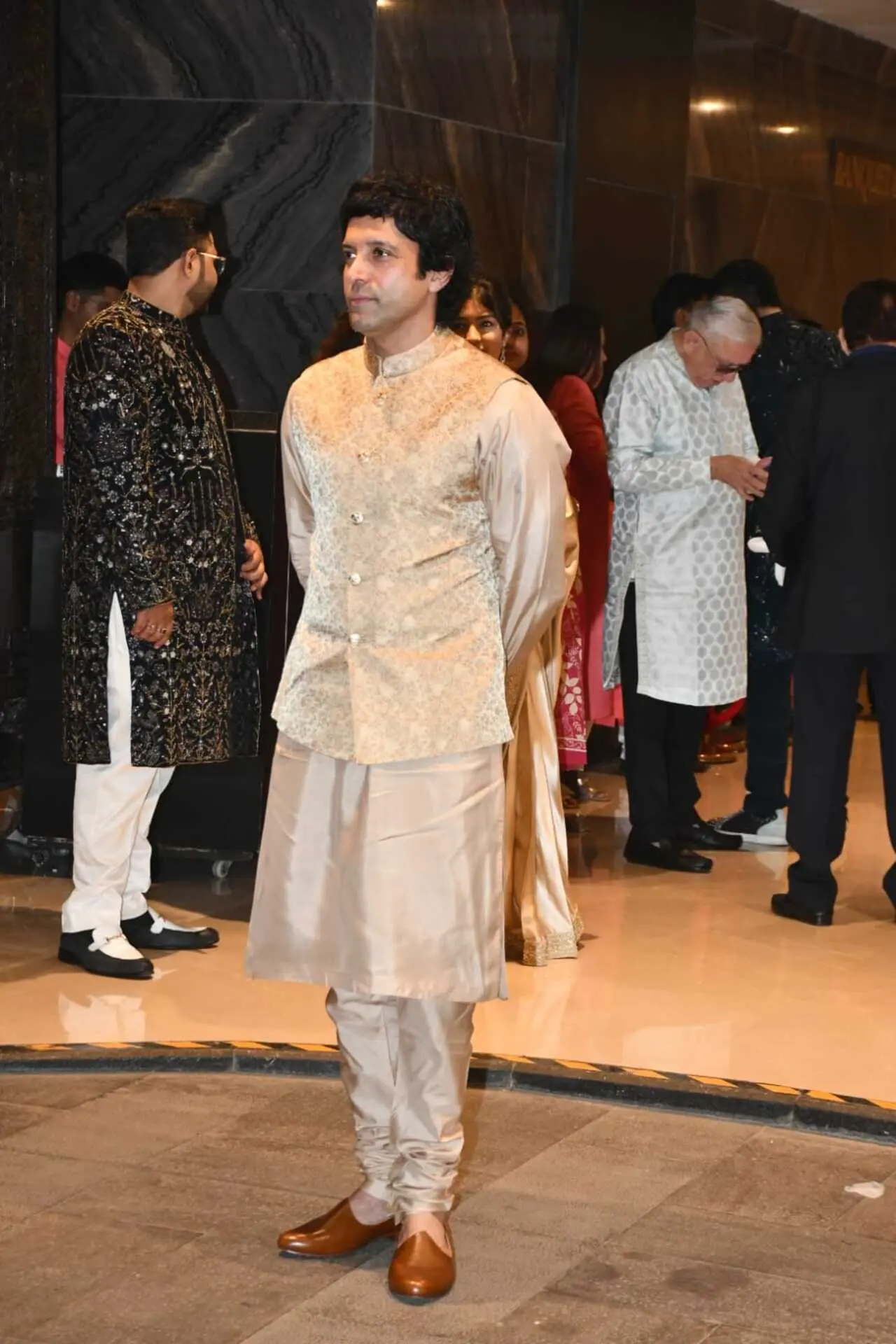 Farhan Akhtar was seen arriving alone for the wedding dressed in an ivory kurta and Nehru jacket.